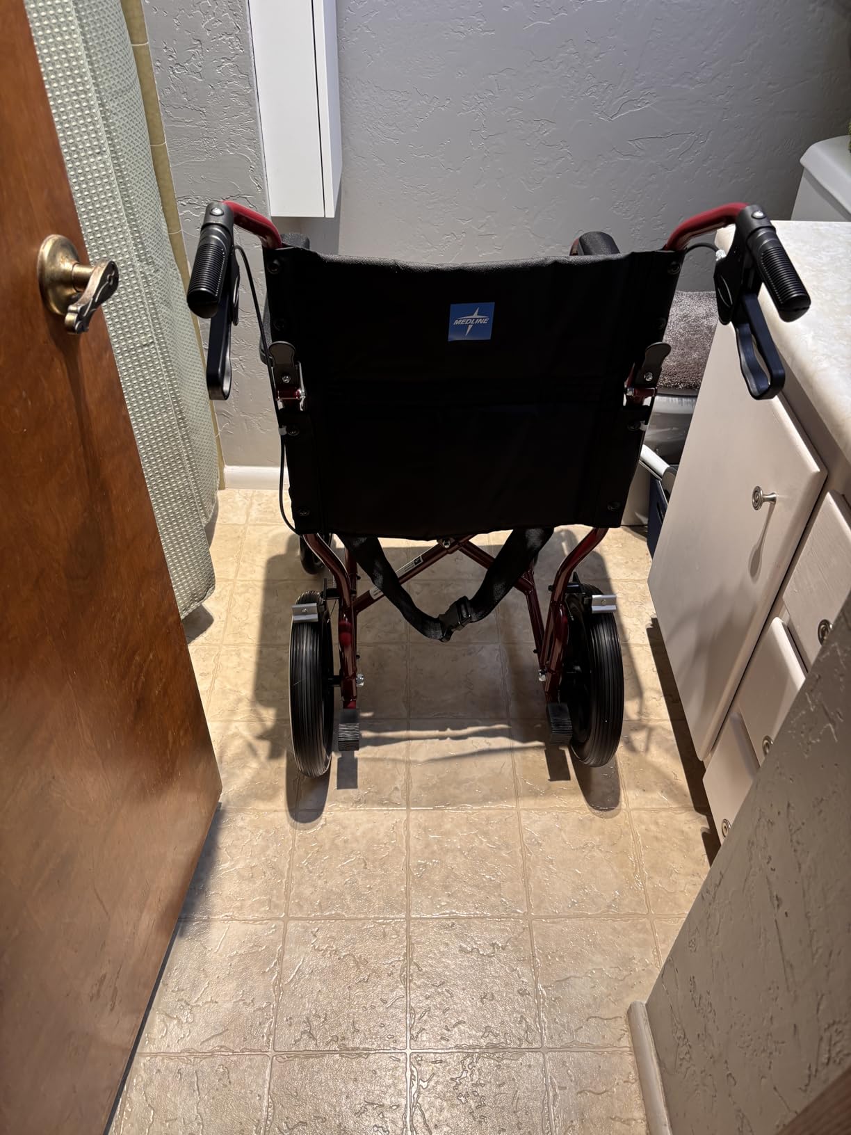 Medline Lightweight Foldable Transport Wheelchair with Handbrakes and 12-Inch Wheels, Red Frame, Black Upholstery customer photo 1